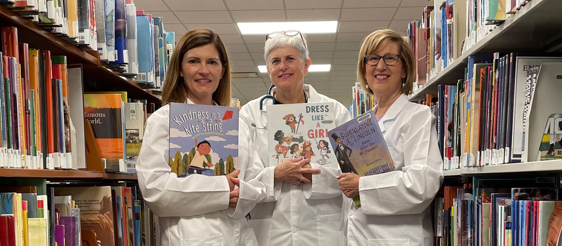 Rhyme Doctors Michelle Schaub Eileen Meyer and Patricia Toht holding their award-winning books. 